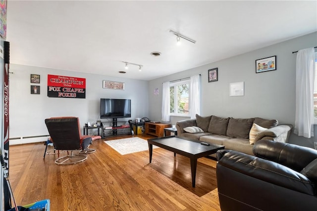 living room with hardwood / wood-style floors, rail lighting, and baseboard heating