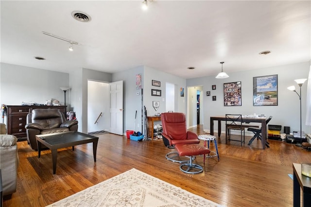 living room featuring wood-type flooring and rail lighting