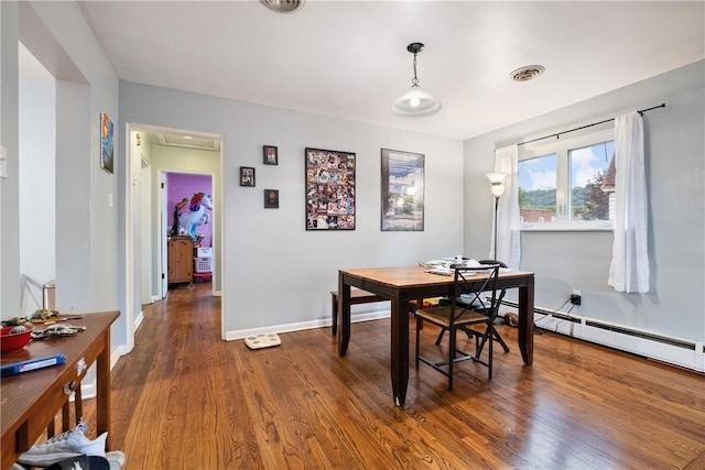 dining area with dark hardwood / wood-style floors and a baseboard radiator