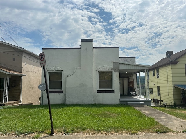 rear view of house with a lawn