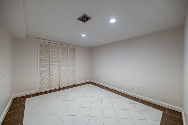 unfurnished bedroom featuring a closet and tile patterned floors