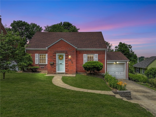 view of front of home featuring a garage and a lawn