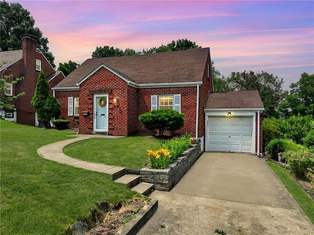 view of front of home with a garage and a lawn