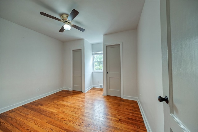 unfurnished bedroom featuring ceiling fan and light hardwood / wood-style floors