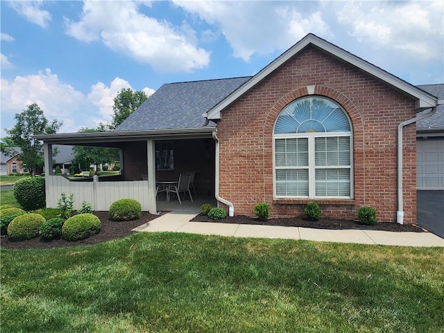 rear view of property with a lawn