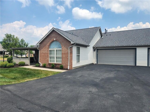 view of front of property featuring a garage and a front lawn