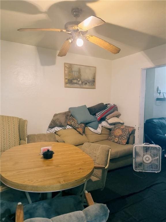 living room with ceiling fan and carpet floors