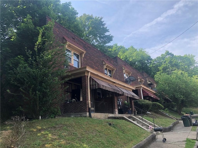 exterior space featuring a front lawn and a porch