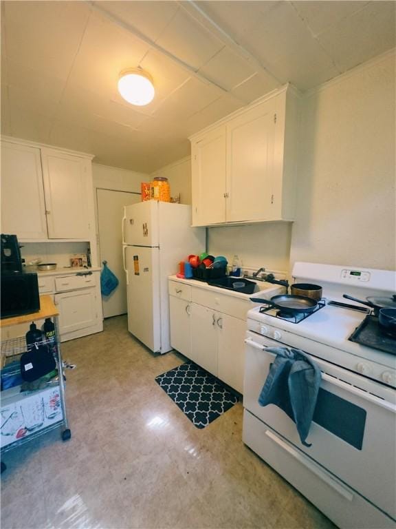 kitchen with white cabinets, white appliances, and sink