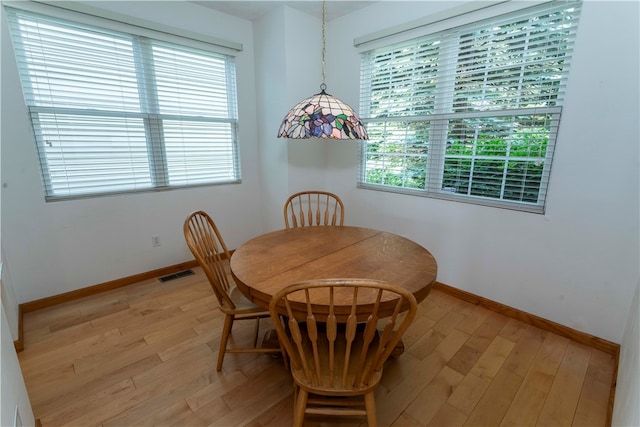 dining space with light hardwood / wood-style floors