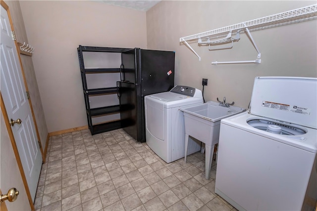 clothes washing area featuring washer and dryer and sink