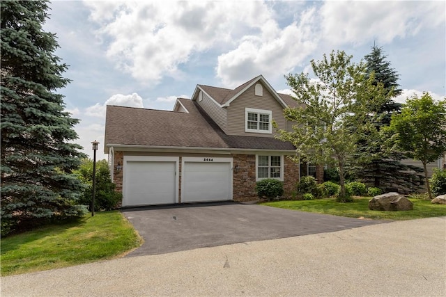 view of front of property featuring a garage and a front lawn