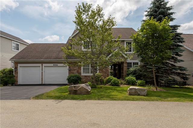 view of front of home featuring a garage and a front yard