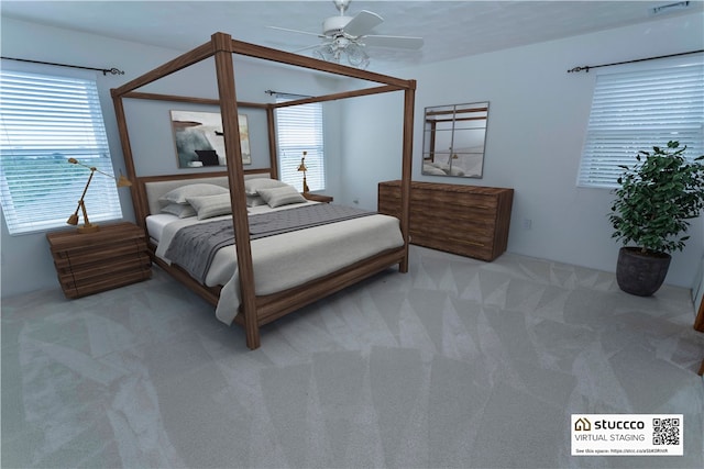 bedroom with ceiling fan and light carpet