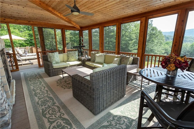 sunroom / solarium with ceiling fan, wood ceiling, and lofted ceiling