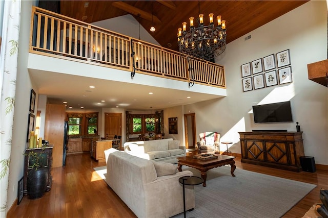 living room with wood ceiling, wood-type flooring, beam ceiling, high vaulted ceiling, and a chandelier