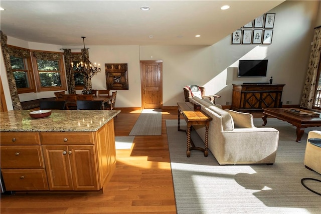 living room featuring light hardwood / wood-style flooring and a notable chandelier