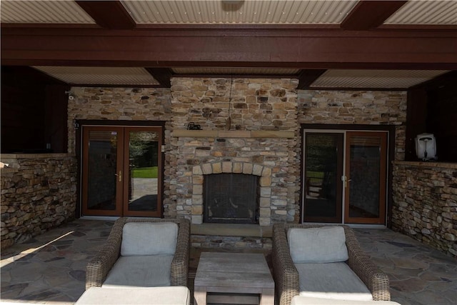 view of patio with an outdoor stone fireplace and french doors