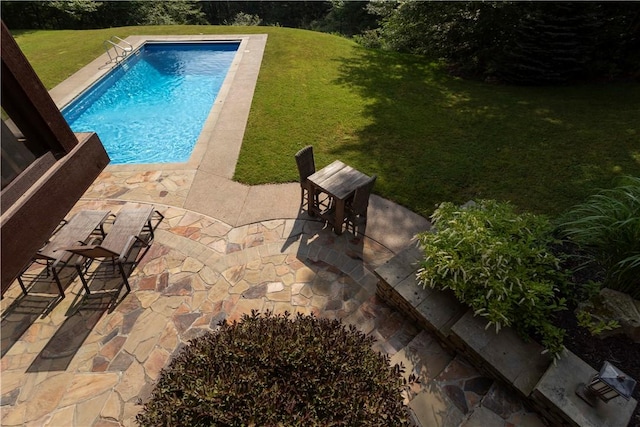 view of pool featuring a yard and a patio area