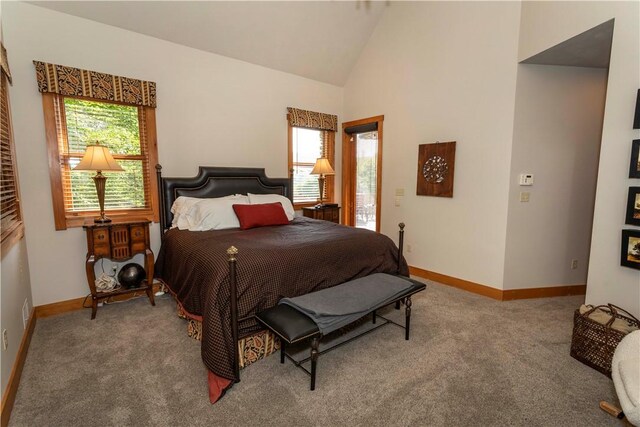 carpeted bedroom featuring multiple windows and high vaulted ceiling