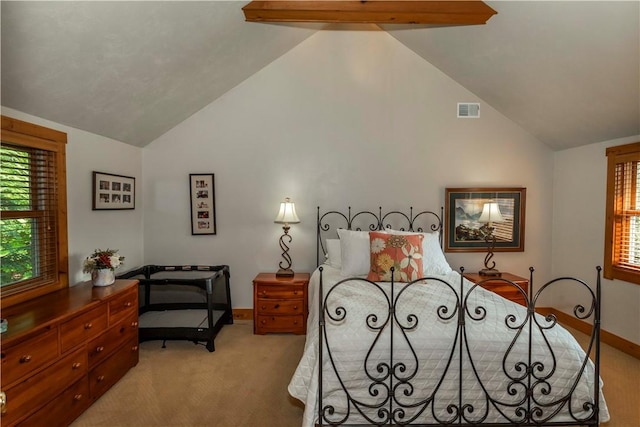 carpeted bedroom with beamed ceiling and high vaulted ceiling