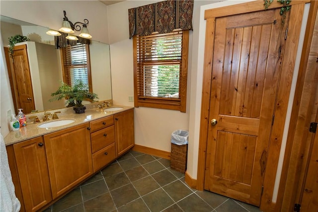 bathroom with tile patterned flooring, vanity, and a chandelier