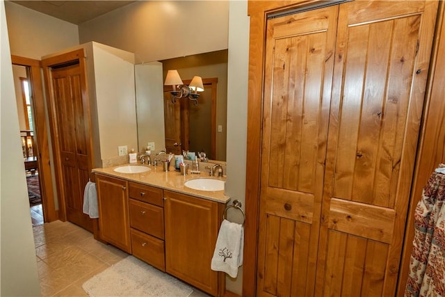 bathroom featuring a chandelier, vanity, and tile patterned floors