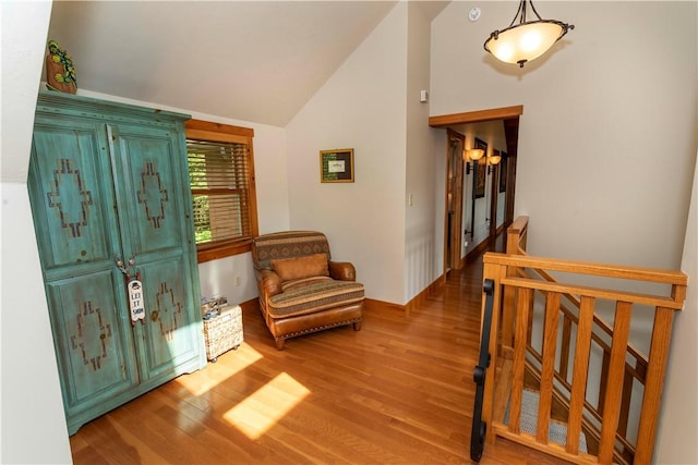 foyer entrance with light wood-type flooring and lofted ceiling