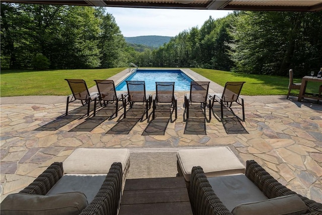 view of pool featuring a yard and a patio area