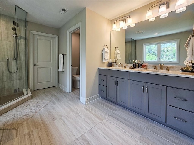 bathroom featuring vanity, toilet, and a shower with door