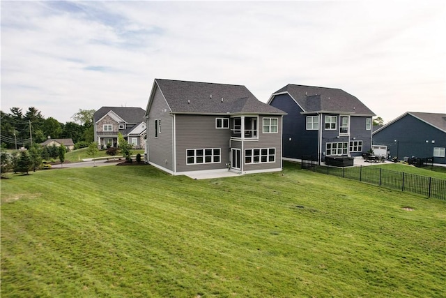 back of property with a yard and a patio area