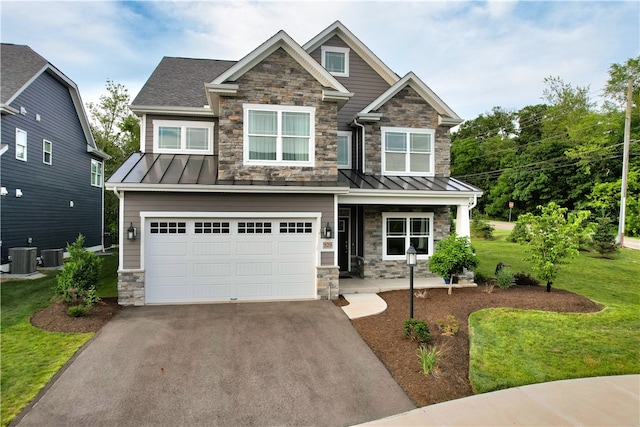 craftsman inspired home featuring central AC unit, a front yard, and a garage