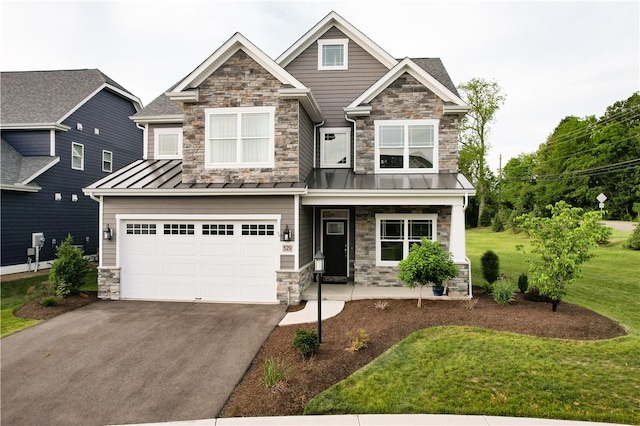 craftsman house with a front yard and a garage