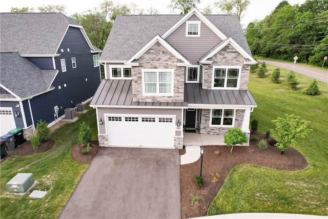 craftsman-style home featuring a front yard and a garage