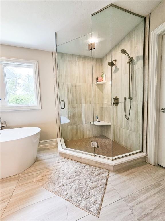 bathroom featuring tile patterned flooring and plus walk in shower