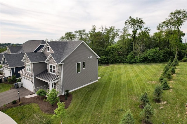 view of home's exterior featuring a lawn and a garage