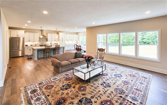 living room featuring hardwood / wood-style flooring and a textured ceiling