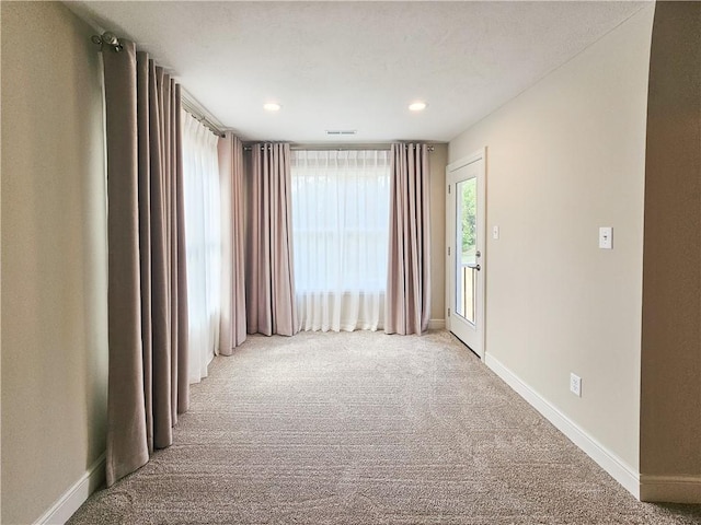 empty room featuring light colored carpet