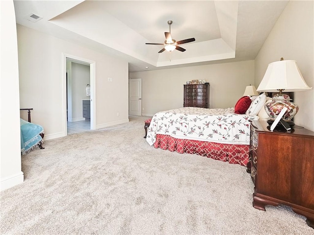 bedroom featuring a tray ceiling, ceiling fan, and carpet