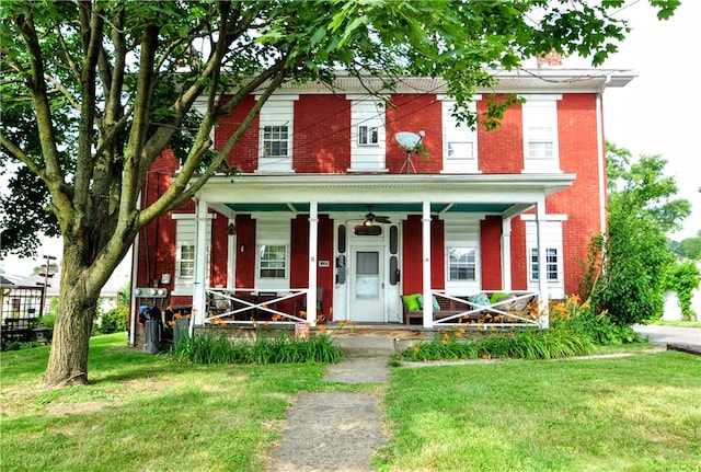 view of front facade with a front lawn and a porch