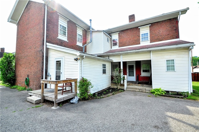 rear view of house featuring a porch