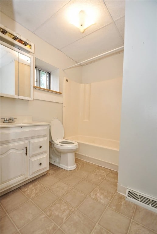 full bathroom with toilet, a drop ceiling, tile flooring, bathing tub / shower combination, and vanity