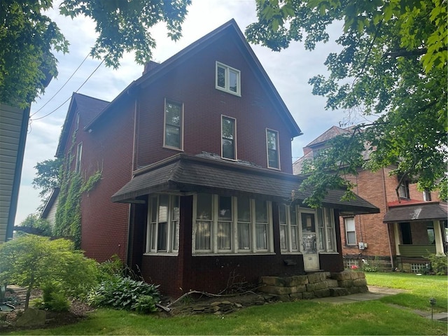 back of property featuring a lawn