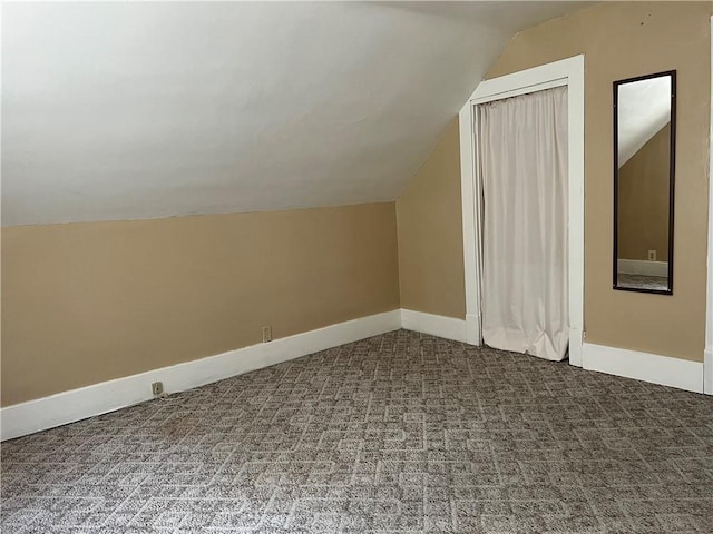 bonus room featuring lofted ceiling, baseboards, and carpet