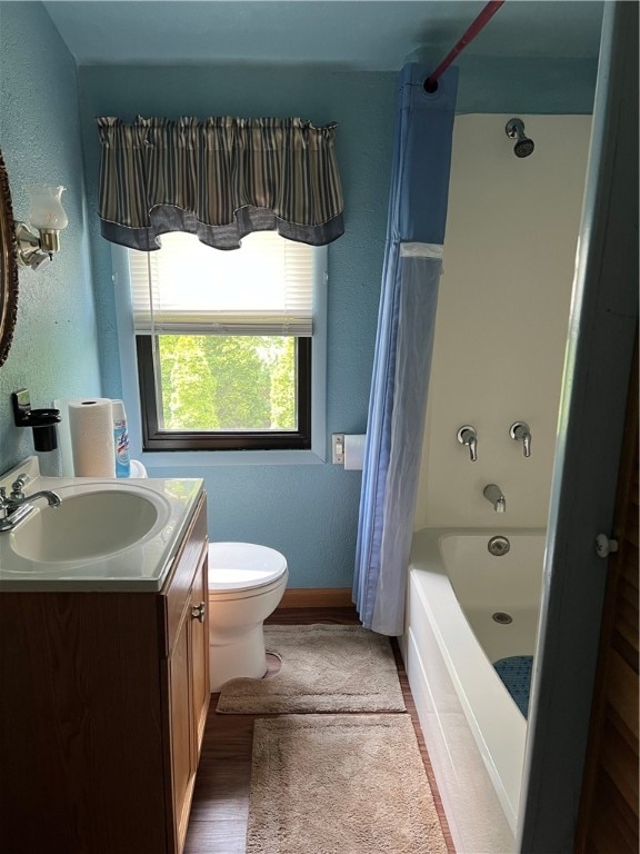 full bathroom featuring wood-type flooring, vanity, toilet, and shower / tub combo