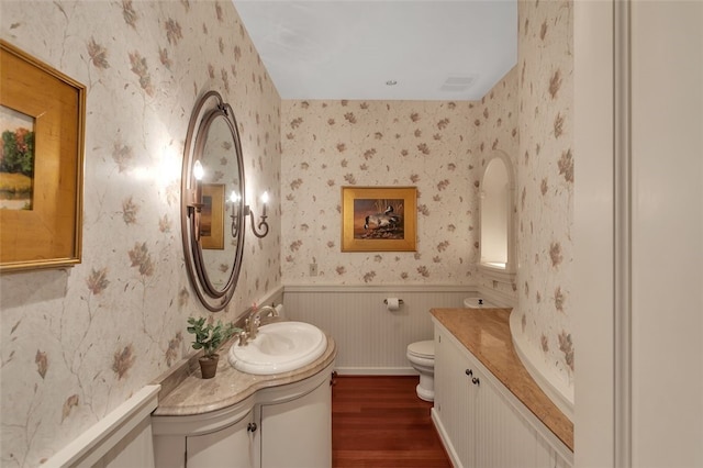 bathroom featuring hardwood / wood-style flooring, vanity, and toilet