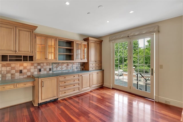 kitchen featuring dark hardwood / wood-style flooring and backsplash