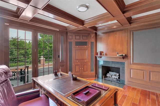 office featuring coffered ceiling, crown molding, a premium fireplace, beamed ceiling, and wood walls