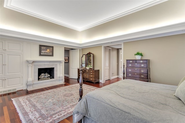 bedroom featuring crown molding and dark hardwood / wood-style flooring