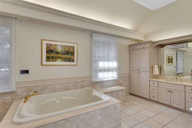 bathroom with tile patterned floors, vanity, lofted ceiling, and tiled tub